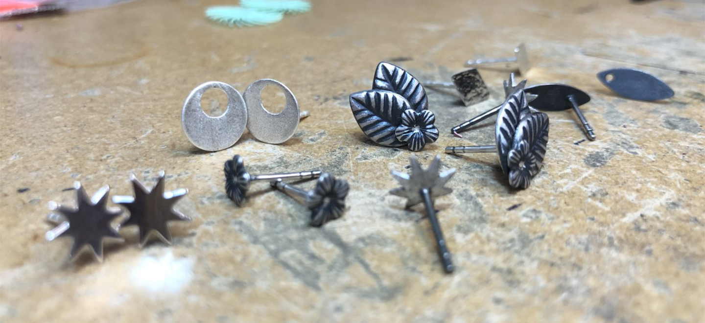 Sterling silver stud earrings laying on table